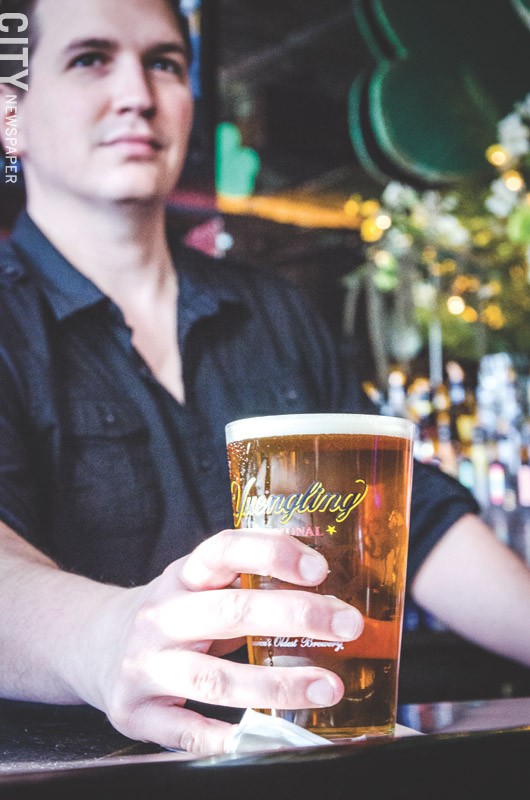 A bartender serves up a cold pint at Avenue Pub. - PHOTO BY MARK CHAMBERLIN