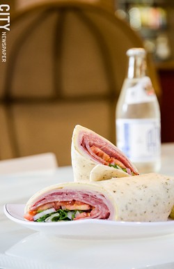 Along with a coffee menu, the recently opened Founders Café serves sandwiches, wraps, and panini, like the Italian trio wrap with an Ouzon soda. - PHOTO BY MARK CHAMBERLIN
