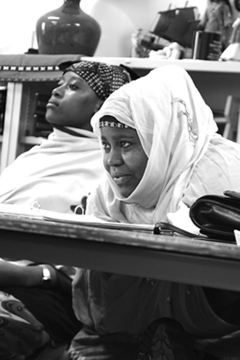At right, Isha Abdi (left) and Khadija Ehow learn English at the Family Learning Center on Hart Street. - MATT WALSH