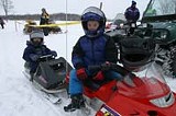 KURT BROWNELL - Kids take a break from the races at a Webster Ridge Runners snowmobiling event.