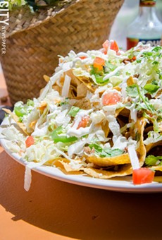 Nachos with chorizo, lettuce, tomato, onion, cheese, and sour cream from Wylie Chayote&#39;s Fine Mexican.