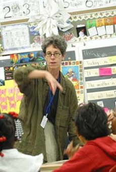 One task at a time: School 29 teacher Dory Driss gives a stedent some individual attention.