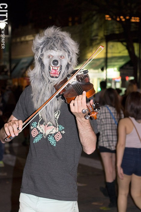 Random Wolf Man (wearing a wolf shirt) played violin on the streets of Austin during SXSW 2013. - WILLIE CLARK