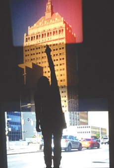 Tara Merenda Nelson's "End of Empire" (seen here with a viewer's silhouette) is a projected collage of the Kodak tower using four formats of film. Nelson's show, "Light Sensitive," is currently on view at Visual Studies Workshop.