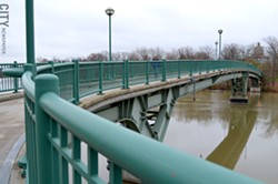 The pedestrian bridge links Brooks Landing in the 19th Ward to the University of Rochester River - Campus. - FILE PHOTO