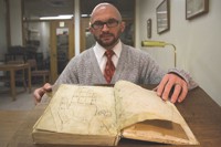 The Sibley Library's Peter Coppen --- and a thousand-year-old illustration. - PHOTO BY JOE BELL