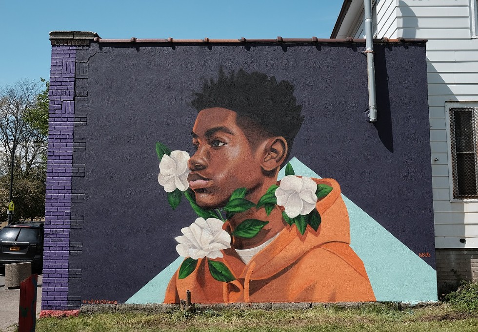 Brittany Williams' mural "Through Tragedy, There's Hope" on the side of Rocky's Pizza on Genesee Street. The piece was a collaboration between Wall\Therapy and Moms Demand Action, a national grassroots organization that pushes for public safety measures. - PHOTO BY JASON WILDER