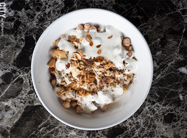 The original fetteh bowl (a comfort food staple) includes chickpeas and yogurt sauce, and is garnished with toasted almonds and aromatic spices. - PHOTO BY JACOB WALSH