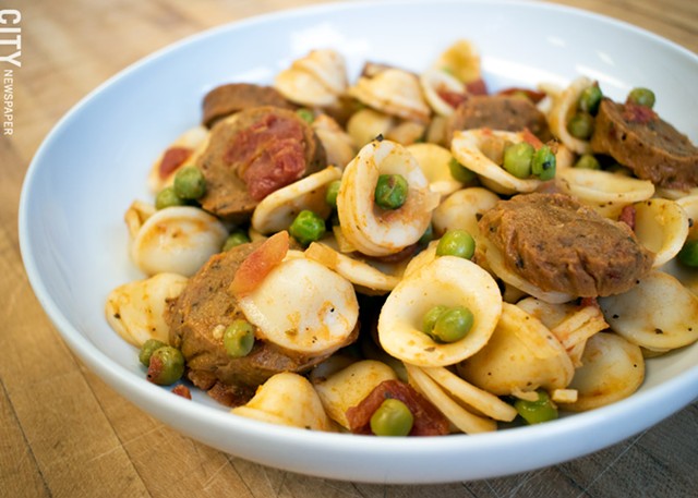 Conchiglie alla Burino, made with vegan butter, Grass Fed's Italian "sausage," tomatoes, white wine, garlic, onions, and peas. - PHOTO BY RENÉE HEININGER