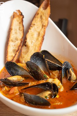 At The Peppered Pig, the bouillabaisse -- a Provençal seafood stew of various fish, shellfish, fennel, saffron, and tomatoes -- contains scallops, mussels, and grouper. - PHOTO BY JACOB WALSH
