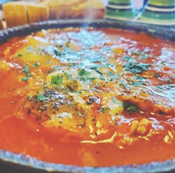 A North African and Middle Eastern classic of eggs poached in tomato sauce, Shakshuka comes in infinite combinations of spices and different cheeses. - PHOTO BY J. NEVADOMSKI