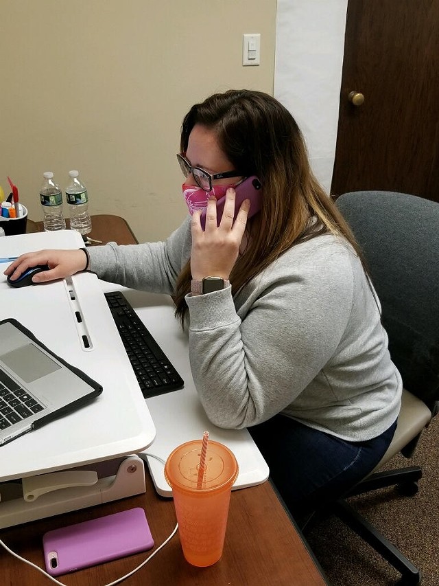 Lyndsey Weilert, the leader of the Monroe County Health Department's isolation and quarantine data management unit, makes a phone call from her desk. - PHOTO PROVIDED BY MONROE COUNTY HEALTH DEPARTMENT