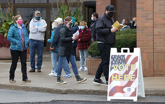 Voters waited outside of the Marketplace Mall polling site for approximately an hour to cast in person ballots Monday afternoon. - PHOTO BY MAX SCHULTE