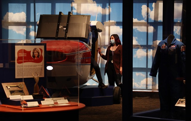 Rochester Museum & Science Center staff member Olivia Shamon works on the flight simulator built out of a decommissioned Cessna. - PHOTO BY MAX SCHULTE