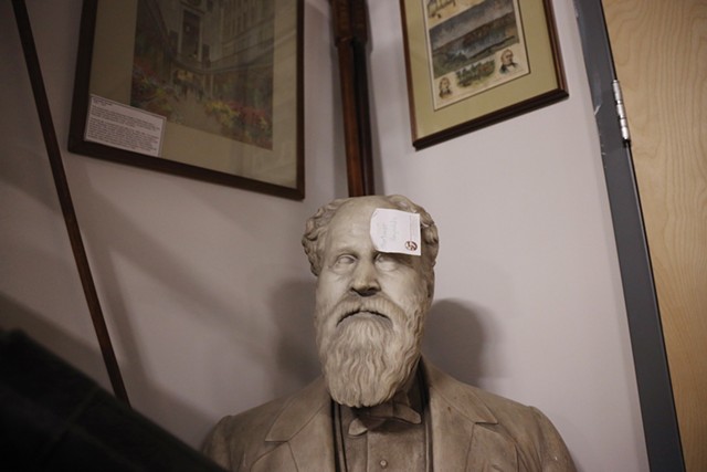 A Post-it note marks the bust of Mortimer Reynolds that sits in a corner of the Rochester Historical Society's new home on University Avenue. - PHOTO BY MAX SCHULTE