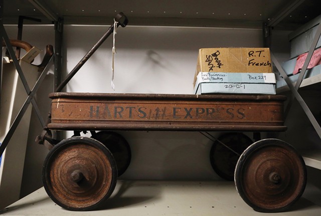 A vintage steel wagon from Hart’s grocery store circa 1900 sits on a shelf at the Rochester Historical Society’s new home on University Avenue. - PHOTO BY MAX SCHULTE