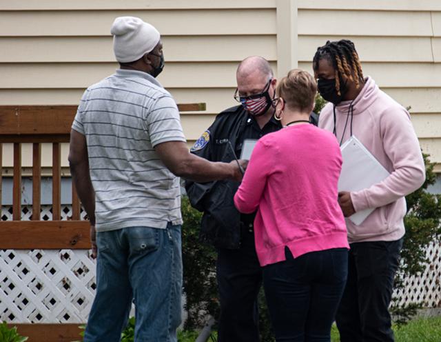 Members of the PIC Team meet with RPD and a case worker for a report of a man in crisis. - PHOTO BY JACOB WALSH
