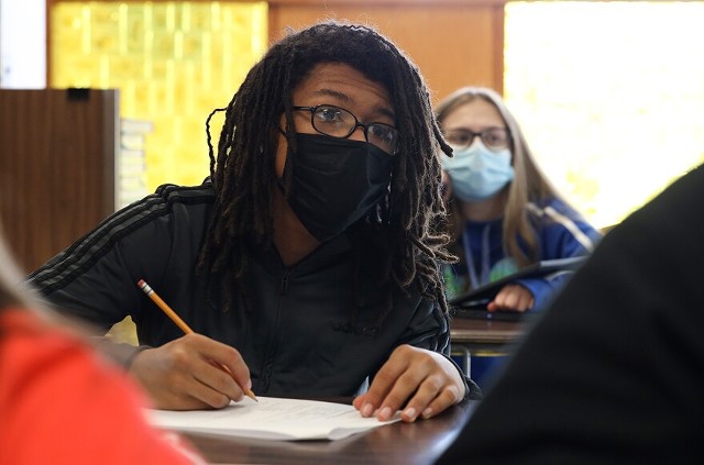 Jordan Harris takes notes during the Personal Money Management class at Hilton High School. - PHOTO BY MAX SCHULTE