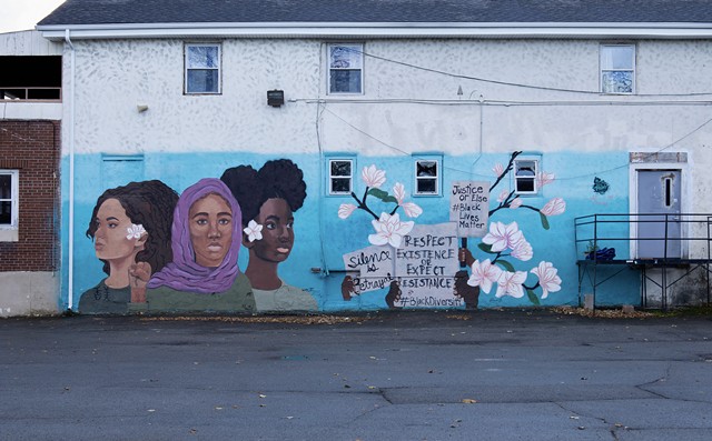 The “Black Lives Matter” mural was painted on the side of The Flying Squirrel Community Space on Clarissa Street by youth artists Nzinga Muhammad, Kaori-Mei Stephens, and Etana Browne in 2017 in collaboration with ROC Paint Division and Wall\Threrapy. - PHOTO BY QUAJAY DONNELL