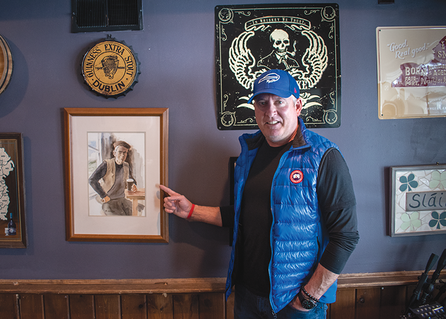Owner Damien Mulconry with a portrait of his grandfather. - PHOTO BY RYAN WILLIAMSON