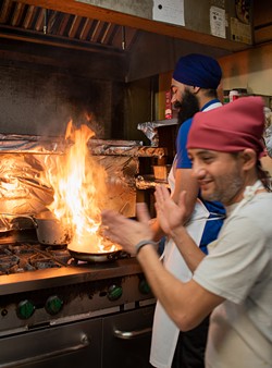 A giant flame is cause for celebration in the Thali of India Kitchen. - PHOTO BY JACOB WALSH