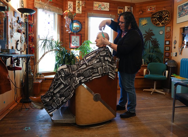 Jennifer Belardino cuts Jeanette Fulton's hair. Fulton lives in Greece and has been going to Belardino at the South Wedge Barber Shop for more than 25 years. - PHOTO BY MAX SCHULTE
