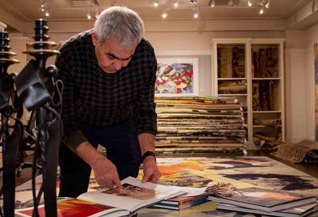Reza Nejad Sattari got the spark for turning art works into rugs while perusing a catalog of the colorful abstract and richly patterned paintings of the late French artist Paul Reynard. “I thought, ‘These are meant to be rugs,’” he said. - PHOTO BY JACOB WALSH