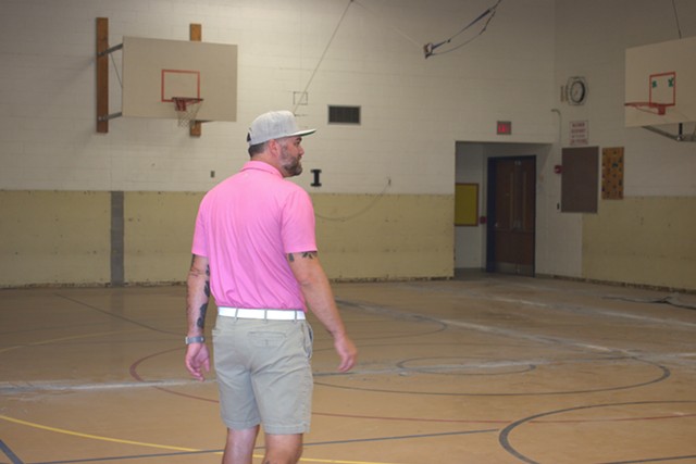Kyle Kennedy walks through the school gymnasium, which will serve as the future brew house. - PHOTO BY GINO FANELLI