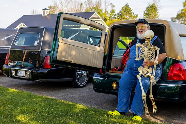 Stephen Miller of Buffalo sits in the back of his hearse with a prop skeleton. "My first car was a hearse," he said. "I love the attention and people get out of my way when I'm driving it." - LAUREN PETRACCA
