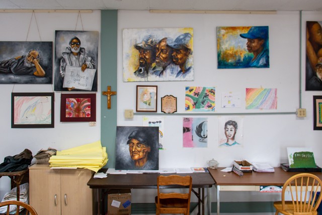 A mixture of paintings by Richmond Futch, Jr. and participants in the free art sessions at St. Joseph's House of Hospitality. - PHOTO BY JACOB WALSH