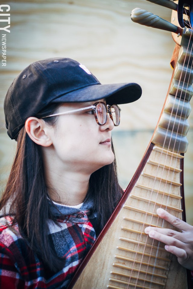 Leah Ou, a Chinese Pipa player, said a lot of market goers stop by to ask her about her instrument, which is a four-stringed, pear-shaped string instrument from China. - “I like it. People are friendly." - PHOTO BY KEVIN FULLER