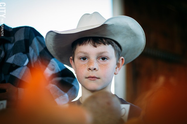 Lucas Welker, who is 7 years old, and his 12-year-old cousin Abraham Amsler both live in Walworth and help operate the Amsler family farm, Oldhome Farm. - Lucas gets up at 6 a.m. to make it to the market for what he calls the “second shift.” Abraham has to get up at 2:30. Lucas and Abraham finished their chores in the dairy barn, which included milking cows, around 10 p.m. the night before. “You get to help out and people get the stuff they need.” - PHOTO BY KEVIN FULLER