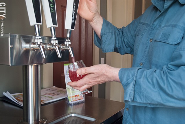Tim Garman of Timbucha pours a cranberry-pear kombucha at Fairport Brewing Company. The biz offers six flavors on tap. - PHOTO BY JACOB WALSH
