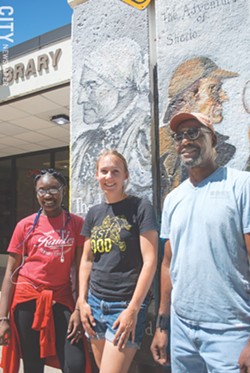 Ebony Singleton, Chloe Smith, and Futch in front of their work at the Arnett Branch Library. - PHOTO BY JACOB WALSH