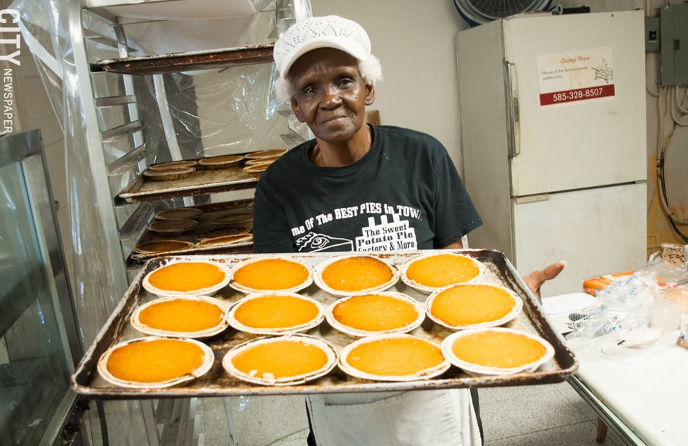 Alberta Jacque presents a tray of fresh pies at Sweet Potato Pie Factory & More. - PHOTO BY JACOB WALSH