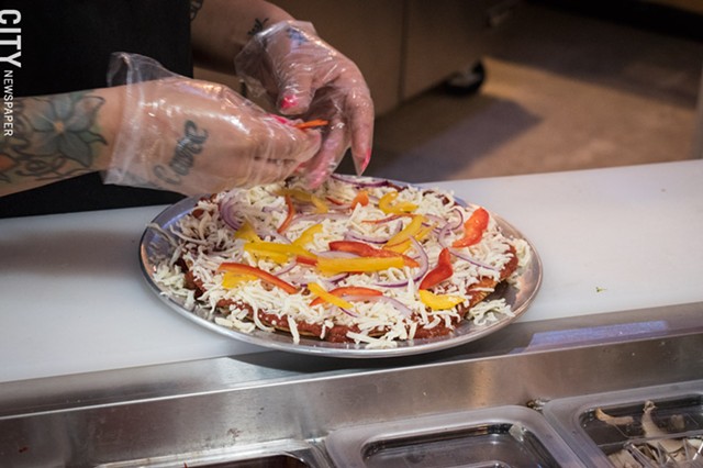 Following the fast-casual model of eateries like Chipotle, the pies at Create A Pizza are created to the customer's specifications. - PHOTO BY JACOB WALSH