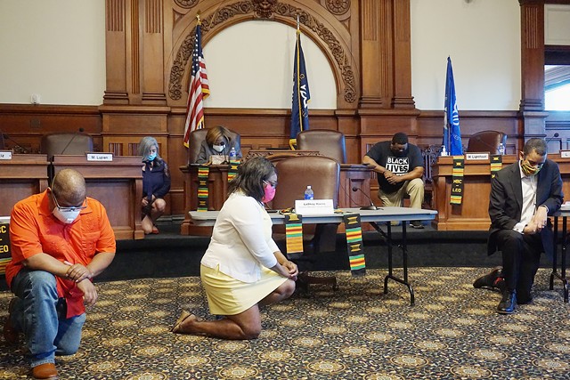 Rochester City Council members kneel in reference to the killing of George Floyd before a news conference on June 15, 2020.