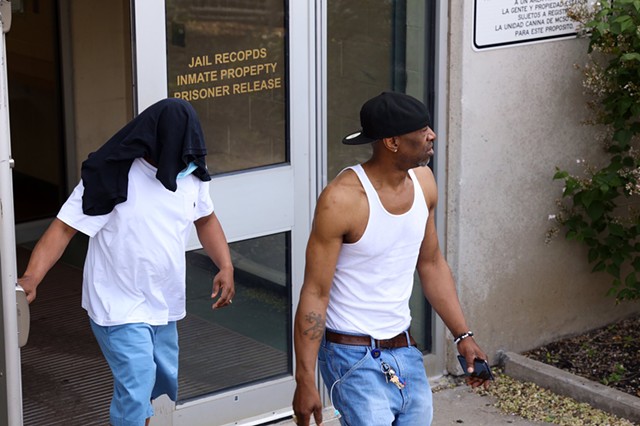 Timothy Granison, left, with head covered, leaves the Monroe County Jail after his arraignment.