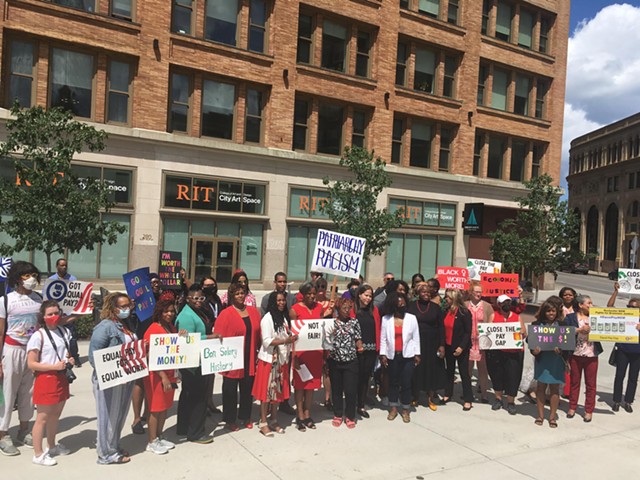 Community members wore red and gathered at the Liberty Pole in downtown Rochester on Aug. 3 in honor of National Black Women's Equal Pay Day.