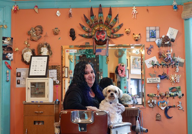 Jennifer Belardino, owner of the South Wedge Barber Shop, with her dog, Angel.