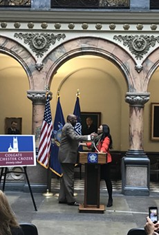 Colgate Rochester Crozer Divinity School President Marvin McMickle and his successor, Angela Sims, at a City Hall press conference announcing Sims' appointment.
