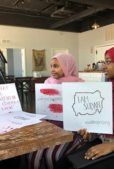 Rana Sulieman (left), Hiba Ahmed, and Olaa Mohamed hold signs they've made for Saturday's protest.