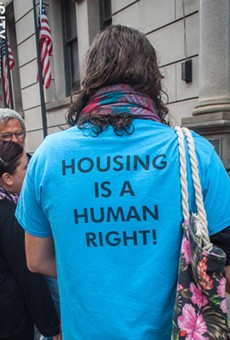 Housing activist Ryan Acuff outside of the Monroe County Office Building prior to a state Assembly hearing on rental housing and tenant protections.