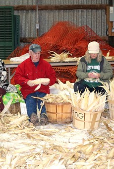 The annual Iroquois White Corn Project includes a post-harvest husking bee, during which volunteers can assist with braiding corn leaves in preparation for hanging and drying.