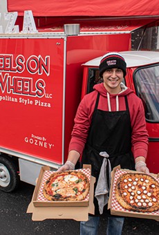 Luis Perez with a couple of Neapolitan pizza pies outside his Peels on Wheels Piaggio Ape
