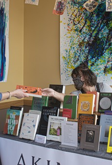 Rachel Crawford (right) of Akimbo Books with a customer at a recent pop-up event at John's Tex Mex.