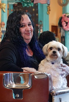 Jennifer Belardino, owner of the South Wedge Barber Shop, with her dog, Angel.