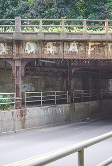 Graffiti created by a group of friends in 1981 to protest the reinstatement of draft registration has remained on the CSX bridge that passes above Penfield Road in Brighton.
