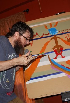 Seth Faergolzia paints while looping music during his show at Abilene.