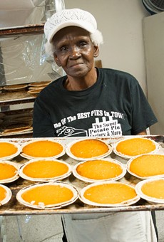 Alberta Jacque presents a tray of fresh pies at Sweet Potato Pie Factory & More.